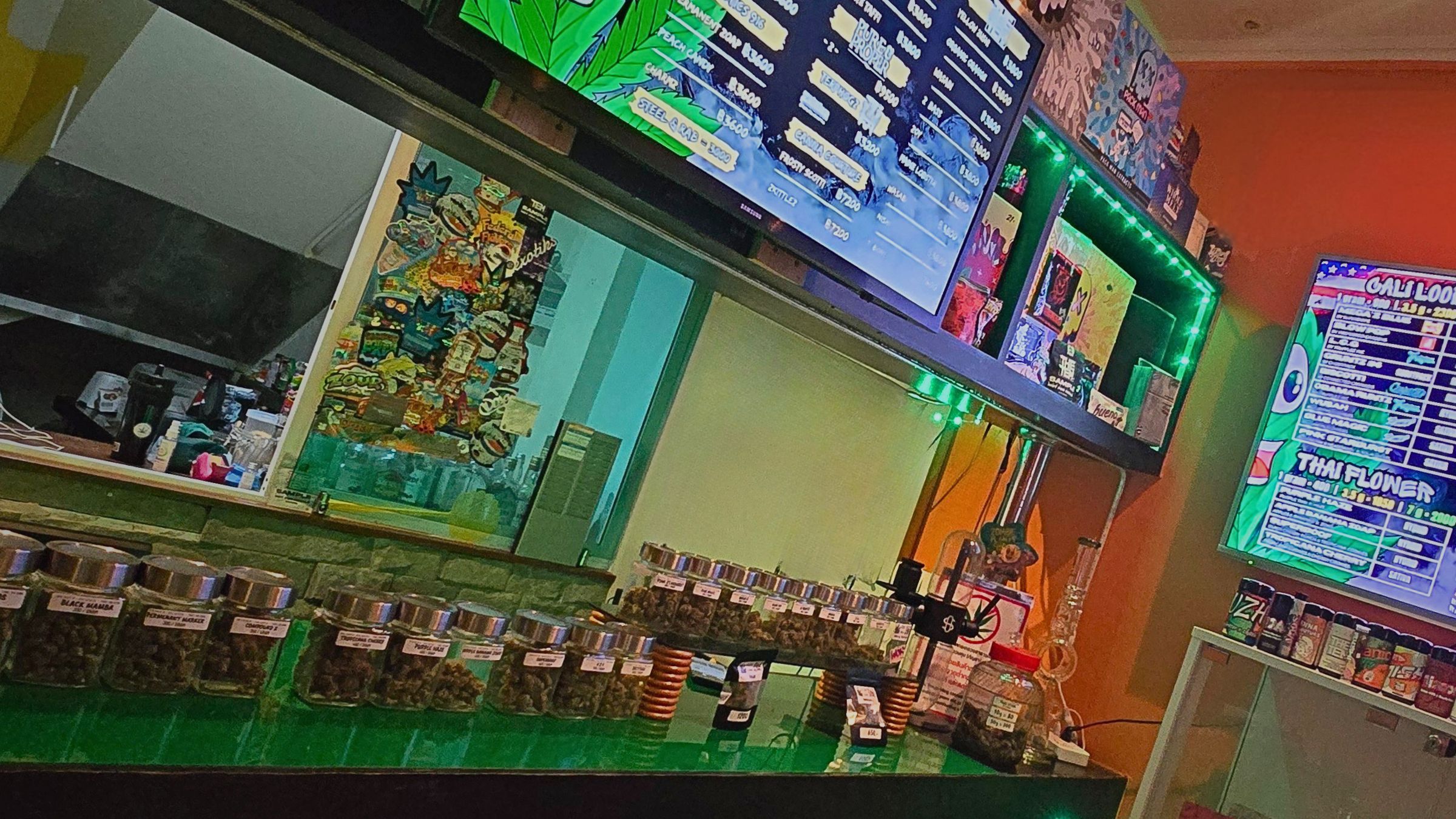 Mr Weed Pattaya dispensary counter with menu boards, glass jars of premium flower and Cali packs on display